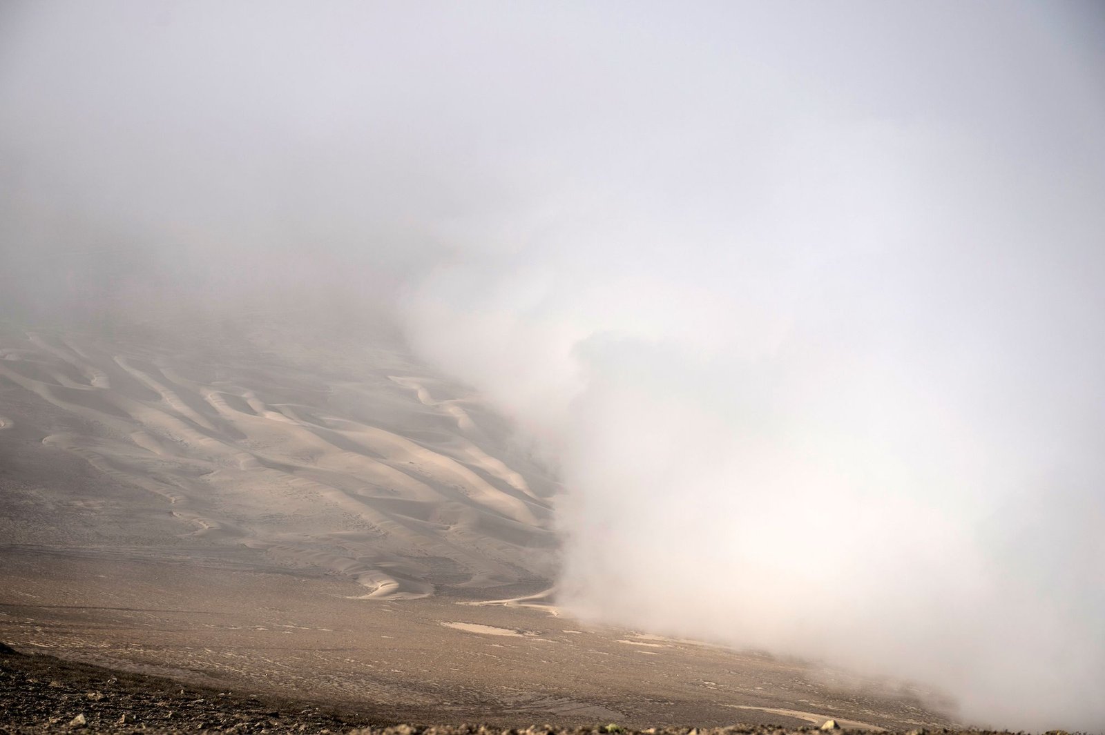 View of fog at the Atacama desert in Iquique, some 2000 km north of Santiago, on April 19, 2016. Catholic University of Chile researchers' challenge is to implement a fog collection system -which uses large pieces of vertical canvas to make the fog condense into droplets- in small communities which don't have drinkable water in Atacama desert. / AFP / MARTIN BERNETTI (Photo credit should read MARTIN BERNETTI/AFP via Getty Images)