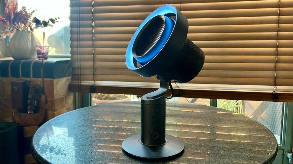 Fan, with its head angled upwards, on a table