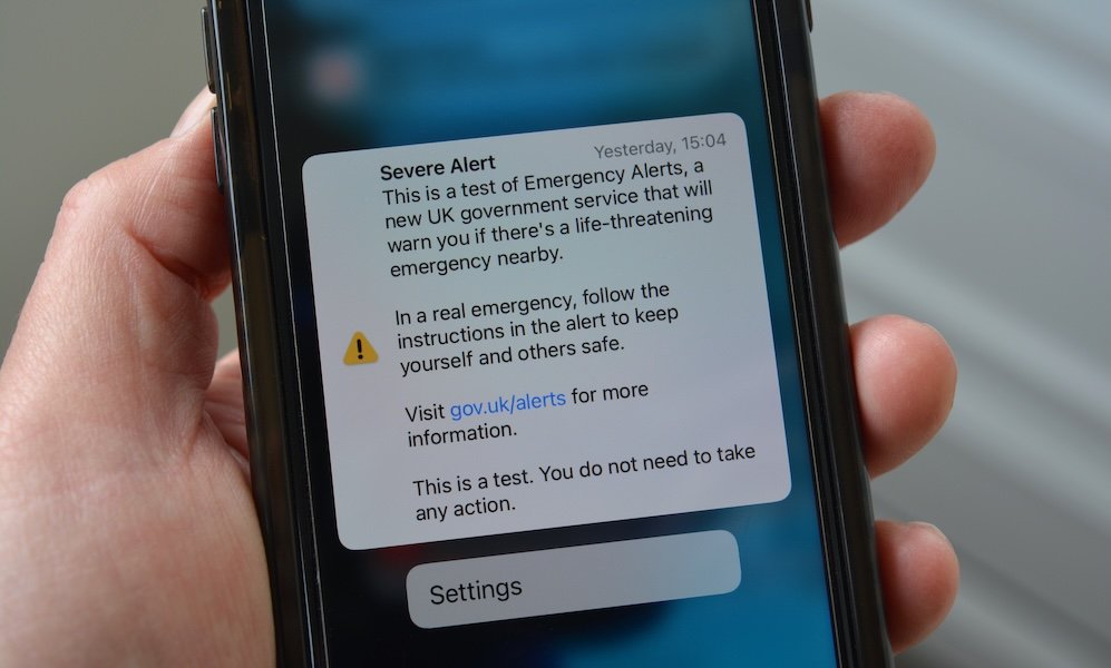 Cellphone in hand with Severe Alert notification